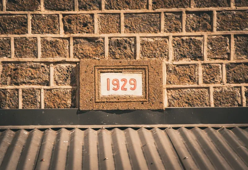 Date plaque reading 1929 set in the basalt stone wall of the former rum distillery at Pavilion 1929, Beau Plan