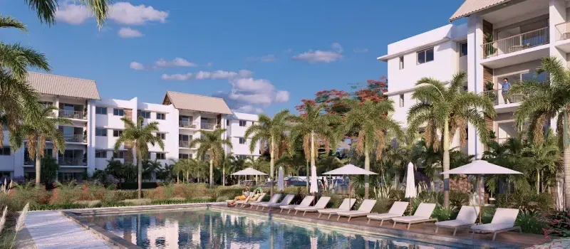 Rendering of Indigo Phase 2 apartment blocks in Beau Plan around a shared pool with sun loungers, parasols and palm trees