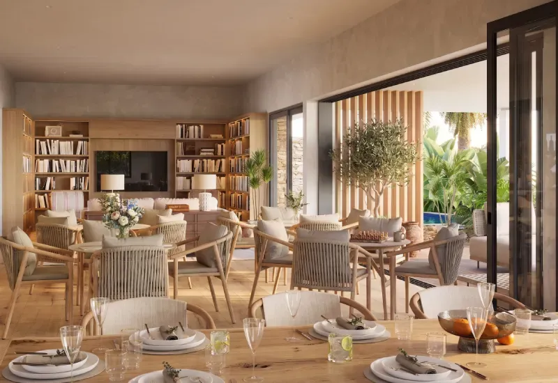 Rendering of the Mosaique retirement village lounge with dining tables, bookshelves and glass doors opening onto a garden
