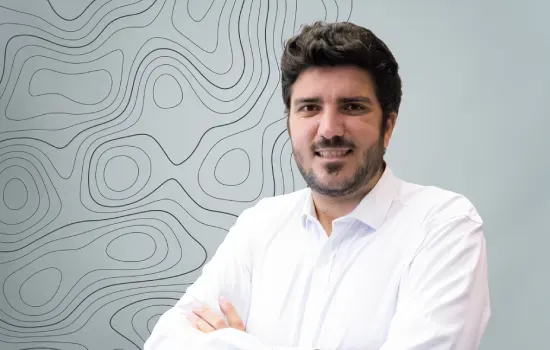 Valentin Hart de Keating, Financial Analyst at Novaterra, smiling with arms crossed in a white shirt