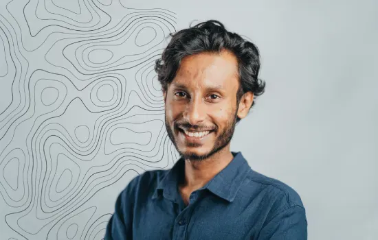 Ratnesh Rajcoomar, Operation Manager at Novaterra, smiling in a blue shirt against a topographic line backdrop