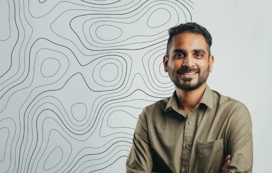 Cheranjeev Padaruth, Accounts Clerk at Novaterra, smiling in an olive shirt before a topographic line pattern