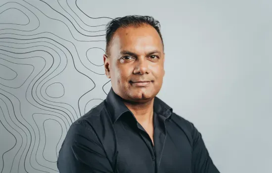 Portrait of Vikash Aodhora, Permit & Regulatory Manager at Novaterra, in a dark shirt against a contour-line backdrop